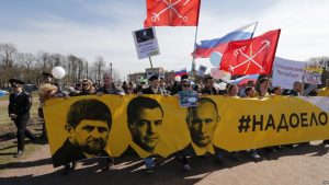 epa05938942 Members of the opposition party 'Open Russia' carry a banner reads as 'Bored' with portraits of Russian President Vladimir Putin, Prime minister Dmitry Medvedev and President of Chechen Republic Ramzan Kadyrov during a May Day rally in St. Petersburg, Russia, 01 May 2017. Labor Day or May Day is observed all over the world on the first day of the May to celebrate the economic and social achievements of workers and fight for laborers rights. EPA/ANATOLY MALTSEV